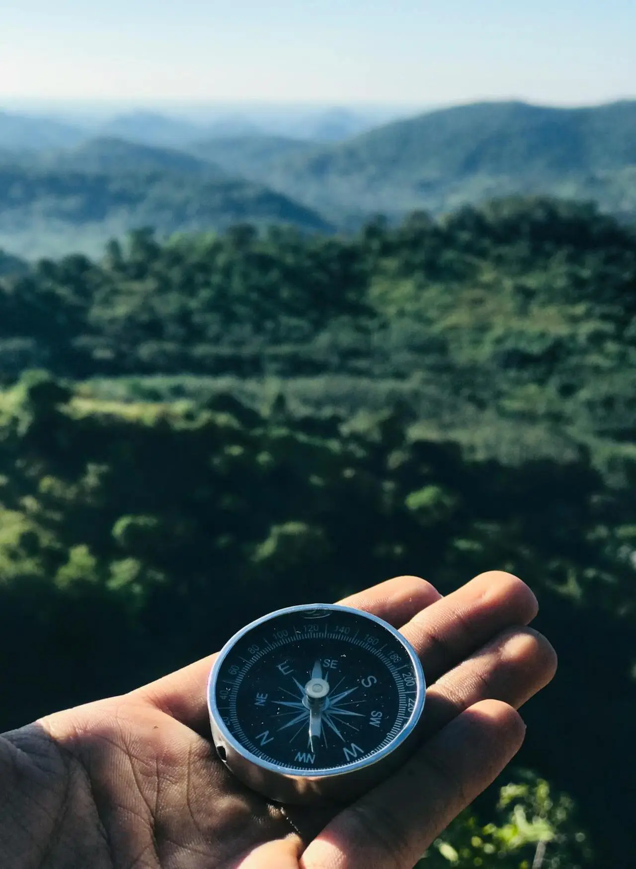 A compass and a valley in the background.